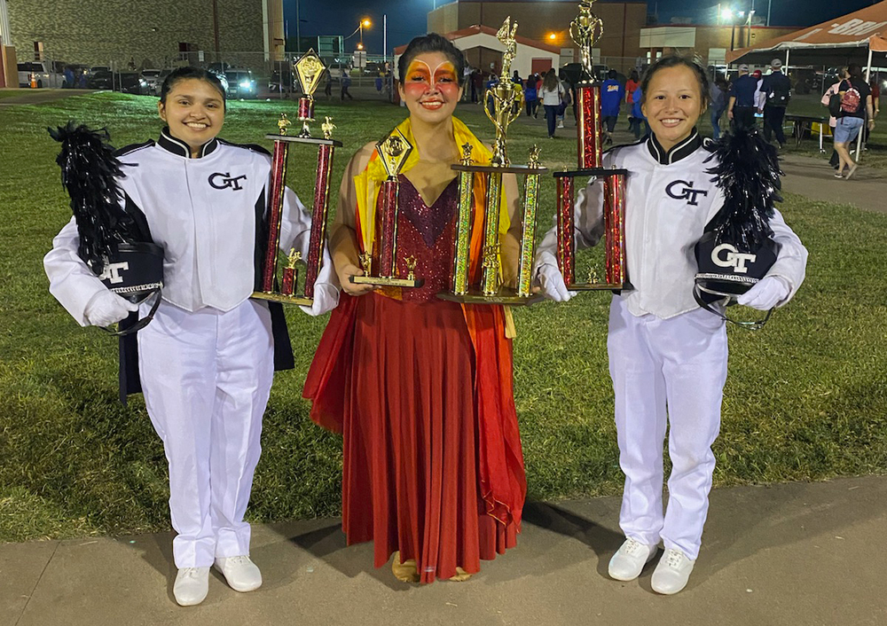Head Drum Major Adrianna Garcia, Color Guard Captain Aerianna Segura, and Assistant Drum Major Gabriella Sertuche receive the trophies after the Goliad High School win Oct. 9 in Calallen and Robstown.