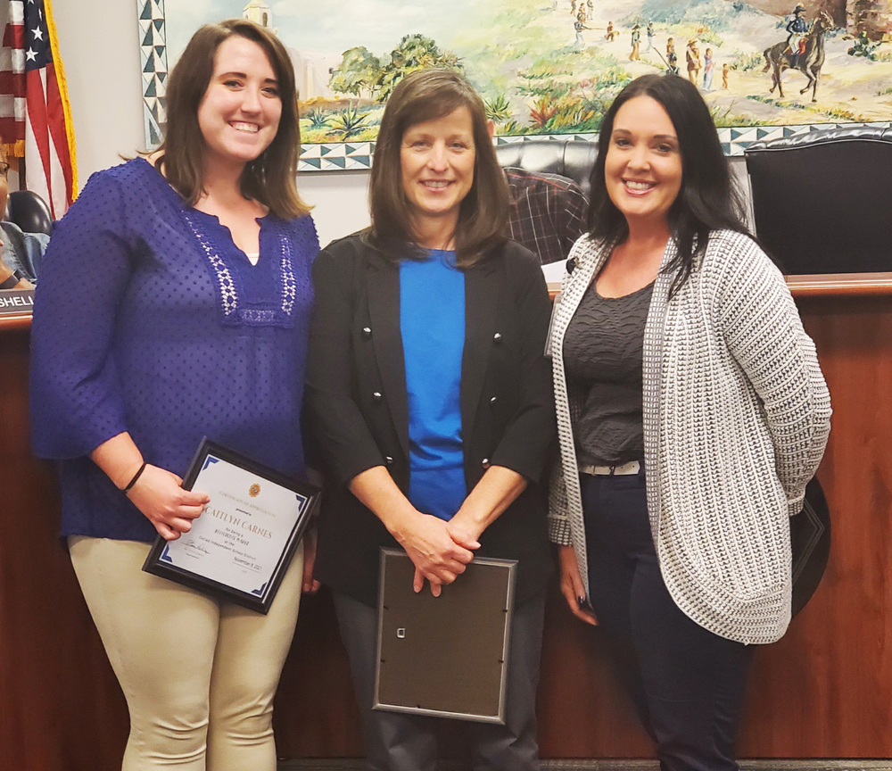Shown in the photo at top are Caitlyn Carnes and Debbie Haney, both named Difference Makers for the month of November​, and Holly Lyon, principal.