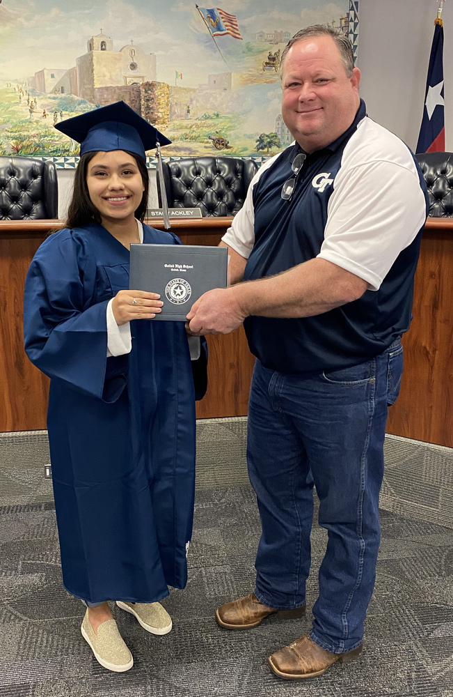 Photo fo Destiny Saldana receiving her diploma from Superintendent Dr. Stacy Ackley
