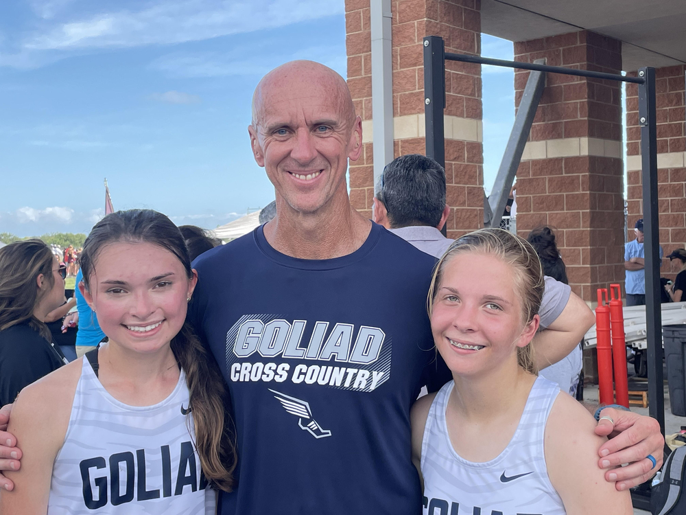 Audrey Winstead, on left, and Ashtyn Franke, both students at Goliad high, stand with coach Tim Knetl after Monday’s cross country meet in Corpus Christi. Winstead placed 52nd while Franke placed 84th out of 179 runners.